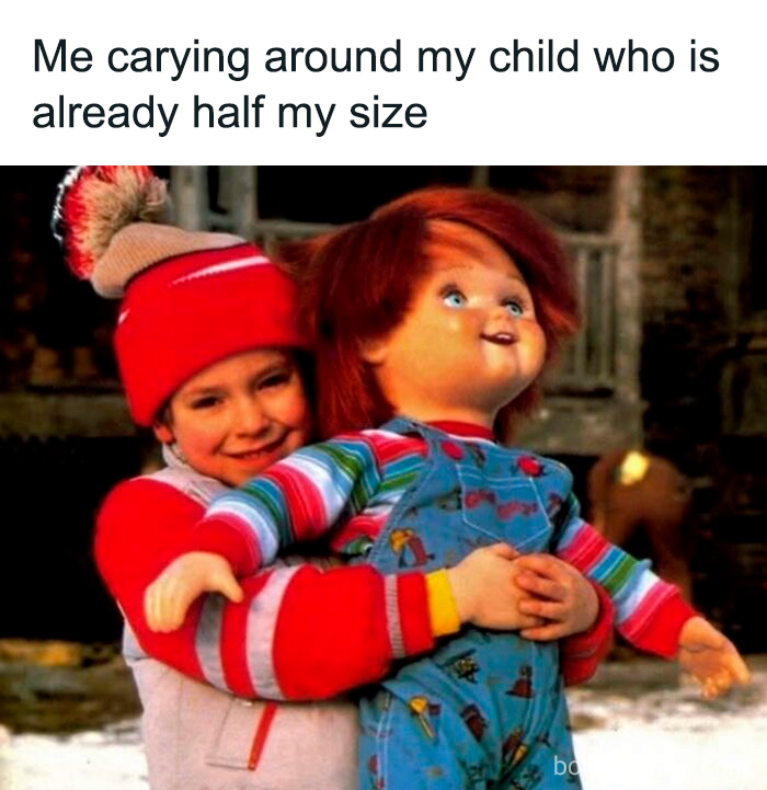 Child wearing a red hat carrying a large doll, illustrating the relatable struggle in funny parenting memes.
