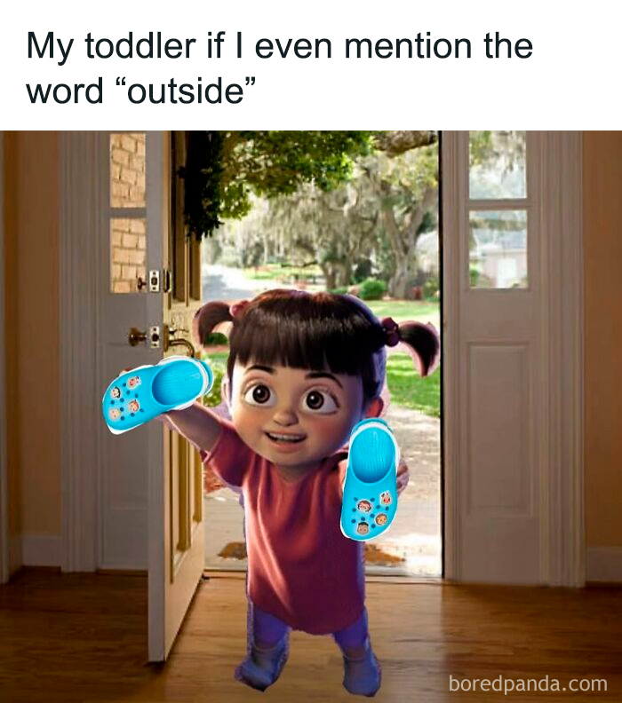 Toddler excitedly holding blue shoes at the door, ready to go outside, capturing funny parenting moments.