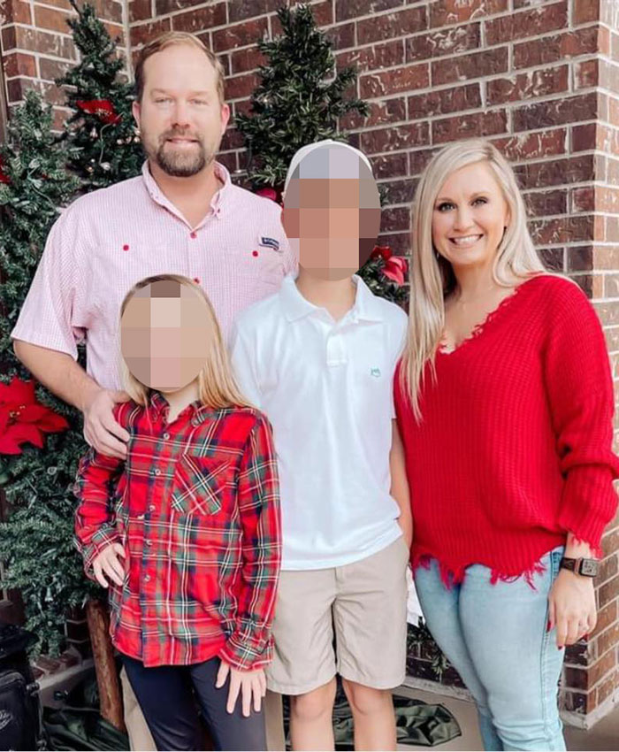 Family posing in front of Christmas trees with religious symbols, highlighting former mayor Misty Roberts’ mugshot controversy.