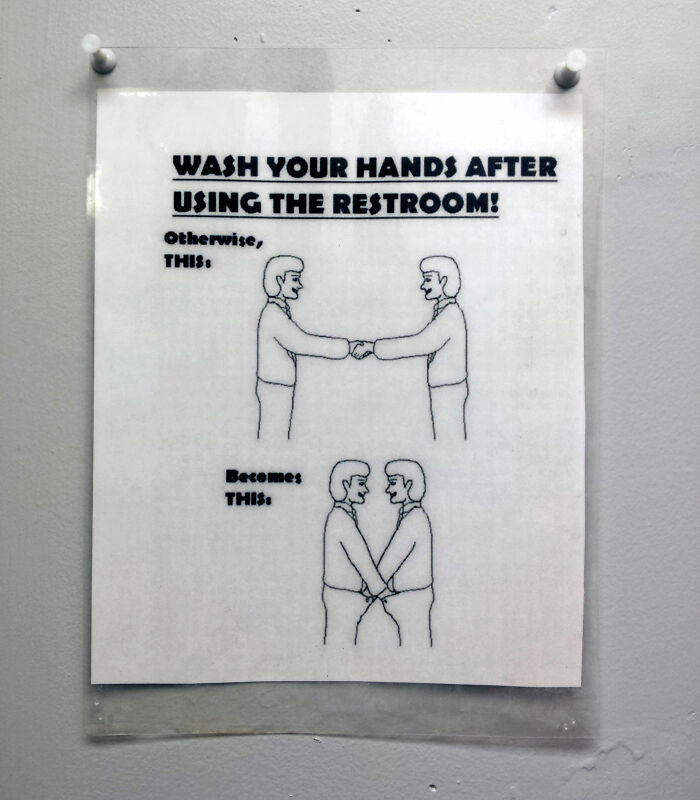 Funny restroom sign warning to wash hands showing handshake turning into holding hands as a humorous warning.