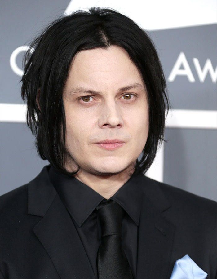 Jack White at an awards event, wearing a black suit and tie, breaking silence after Taylor Swift jab backlash.