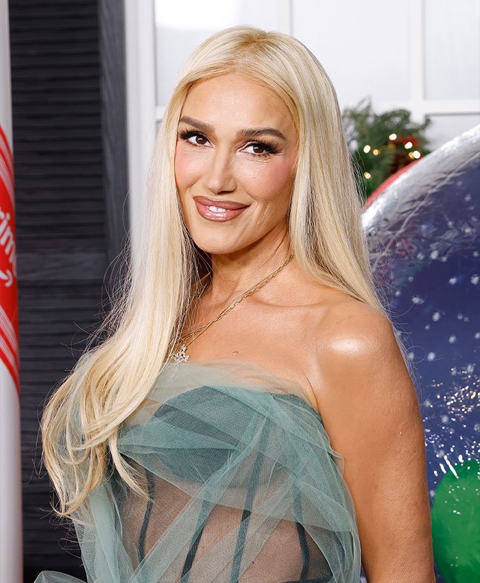 Gwen Stefani smiling in a green tulle dress as she addresses her Christian pivot after promoting anti-abortion app.