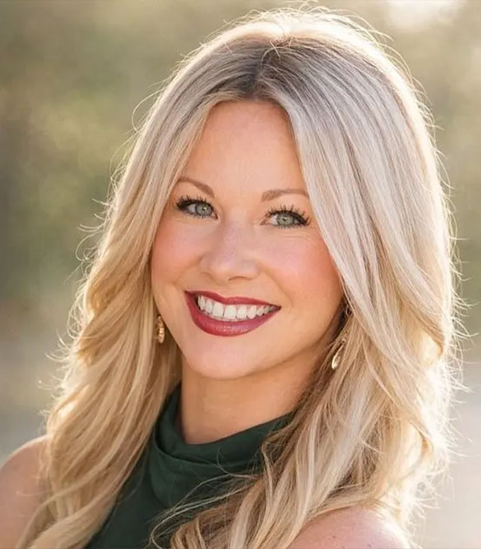 Smiling blonde teacher with long hair posing outdoors in natural light, related to viral teacher marriage update after student scandal.