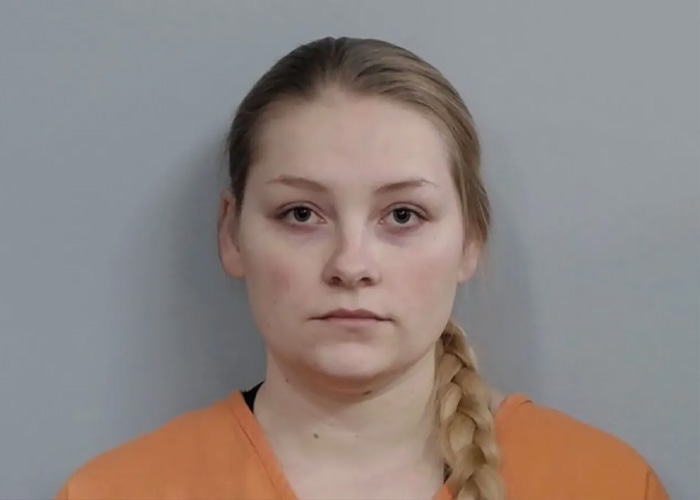 Cheerleader Laken Snelling with braided hair, wearing an orange shirt, related to Snapchat history and newborn passing details.