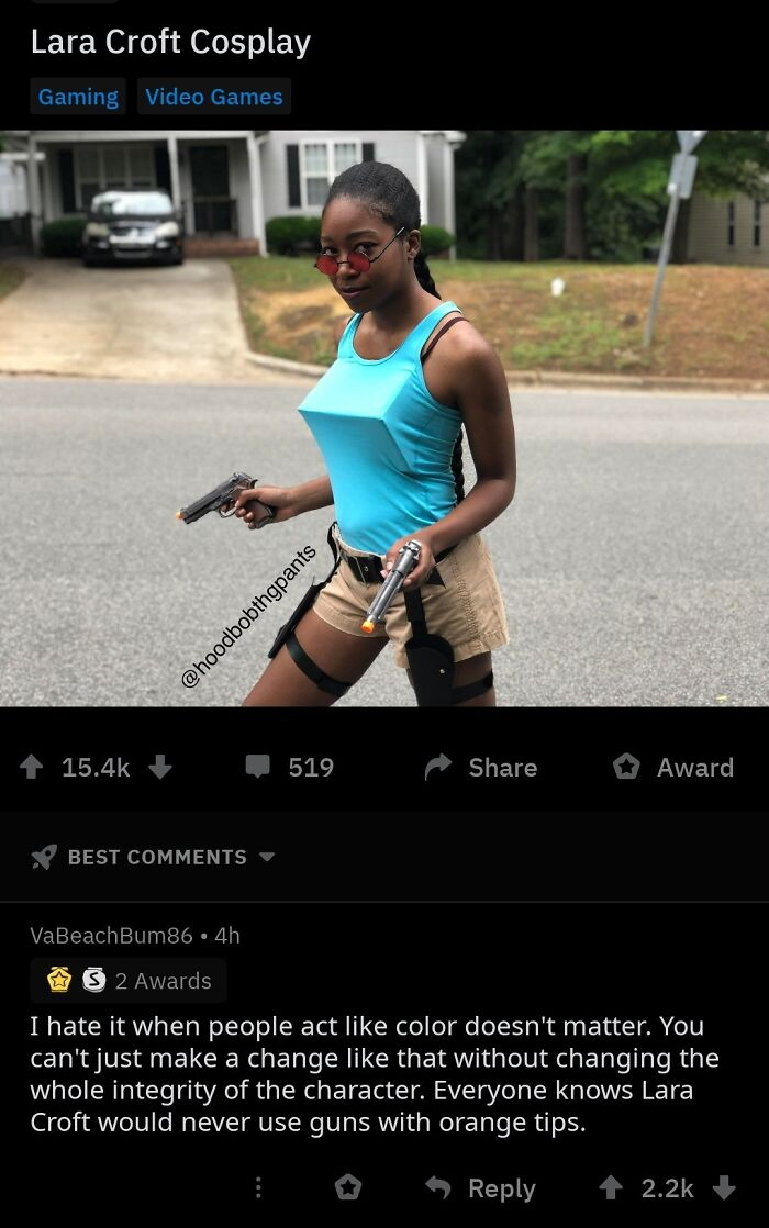 Cosplayer dressed as Lara Croft holding two guns with a confident pose, embodying gaming and video game culture.