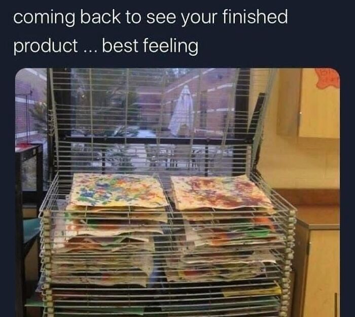 Art drying rack filled with colorful children's paintings showing a 90s childhood activity no longer common.