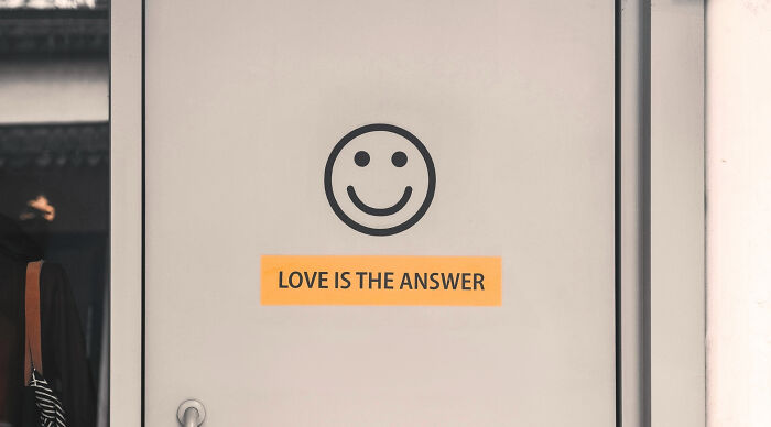Smiley face symbol above text reading love is the answer, illustrating answers in quiz context.