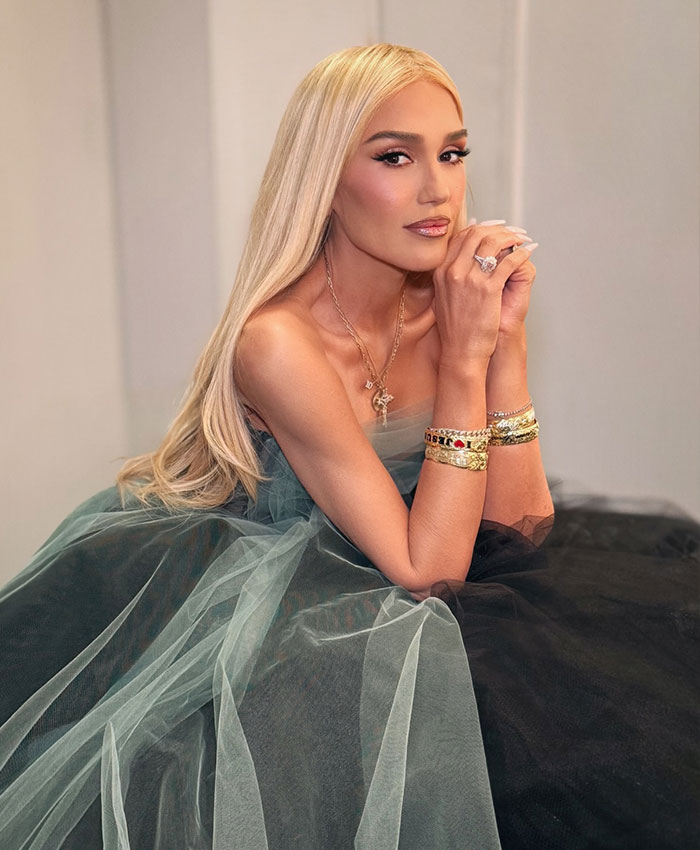 Gwen Stefani posing elegantly in a sheer gown, addressing her Christian pivot after promoting an anti-abortion app.