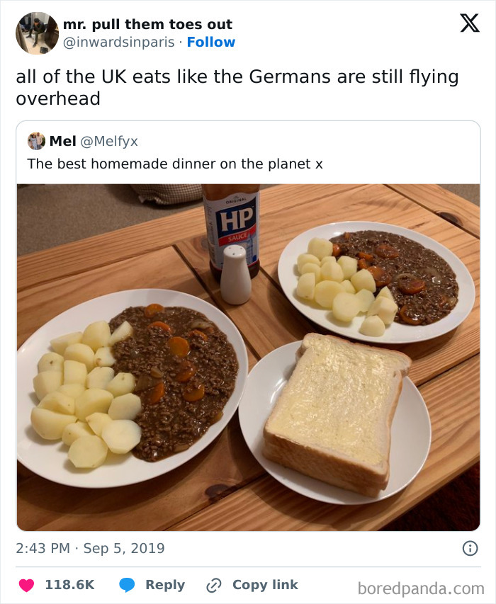 Two plates of homemade British stew with potatoes, a slice of buttered bread, and a bottle of HP sauce on a wooden table.