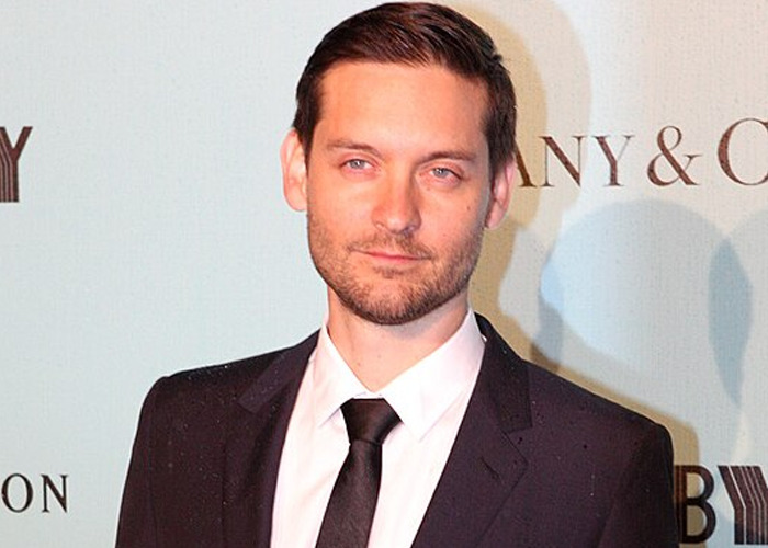 Actor in a black suit at a formal event, illustrating celebrity encounters with raging jerks stories.