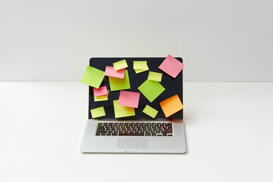 Laptop screen covered with colorful sticky notes representing practical psychology tricks for real-world situations.
