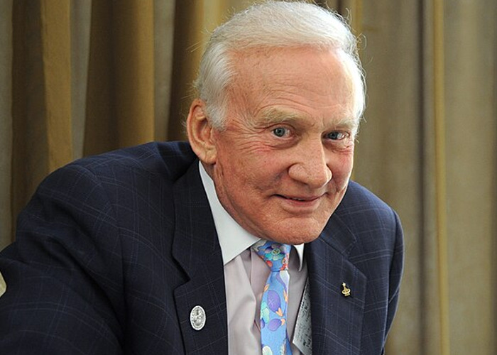 Elderly man in a suit smiling, representing people who met celebrities that turned out to be raging jerks.