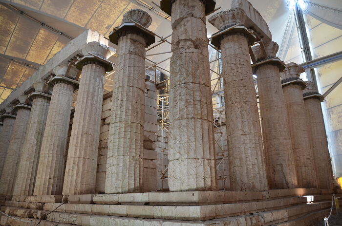 Ancient columns of an iconic landmark under restoration, illustrating popular myths about iconic landmarks around the world.