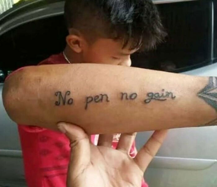Tattoo fail showing a misspelled phrase inked on forearm, highlighting permanent regrets from bad ink ideas.