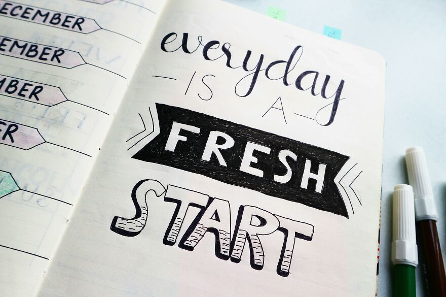 Open notebook with motivational lettering saying everyday is a fresh start, illustrating practical psychology tricks concept.
