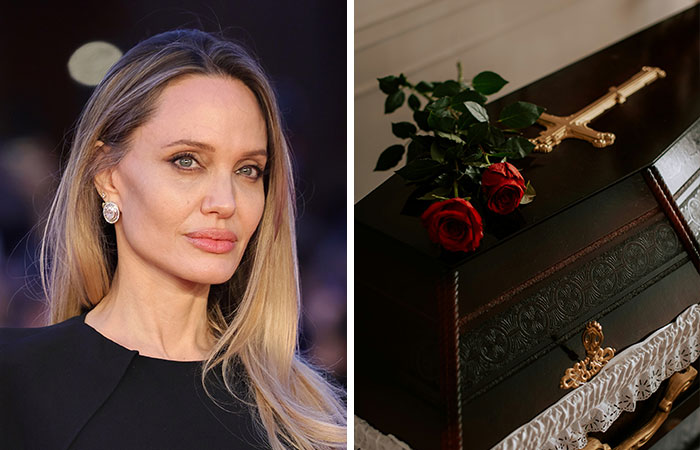 Famous woman with long blonde hair next to a dark wooden coffin adorned with red roses and a gold cross.