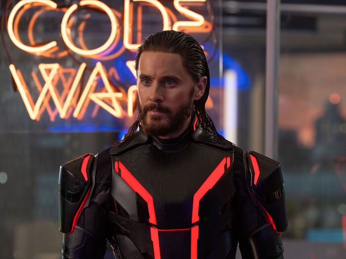 Actor in futuristic armor suit standing indoors, illustrating celebrities people used to like but now hate.