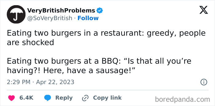 Tweet from VeryBritishProblems humorously contrasting reactions to eating burgers in the UK, highlighting unique British social norms.