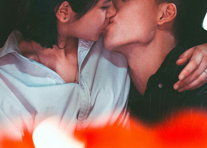 Couple kissing intimately, illustrating a moment that could reveal the true nature of a happily divorced relationship.