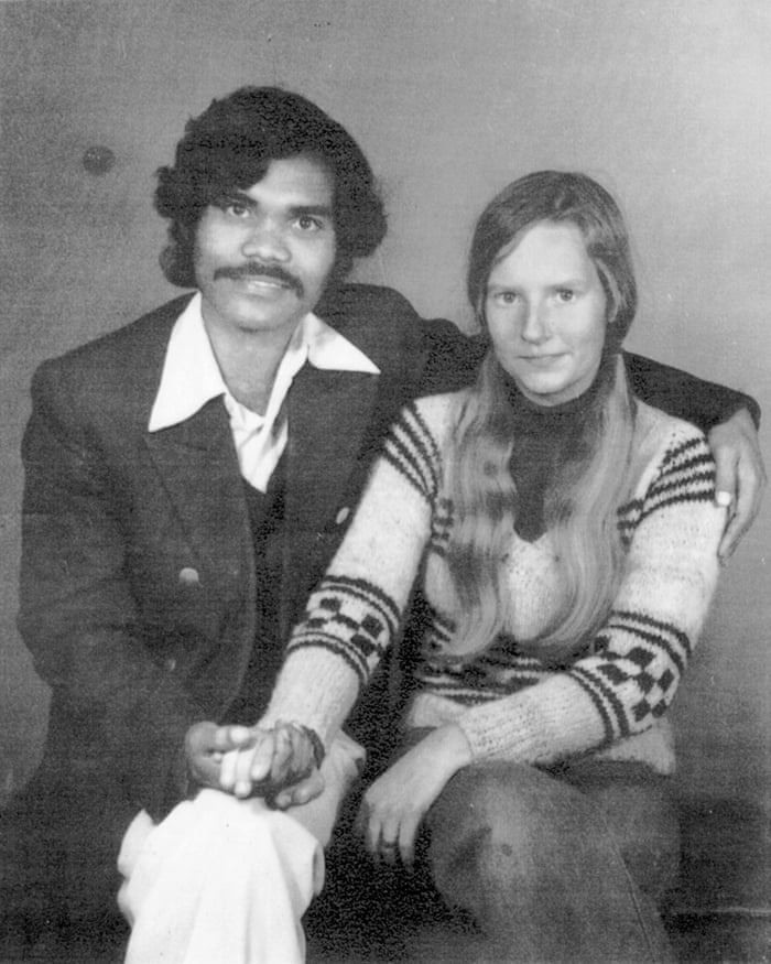 Couple holding hands and sitting close together, illustrating crazy things people did for love in the past.