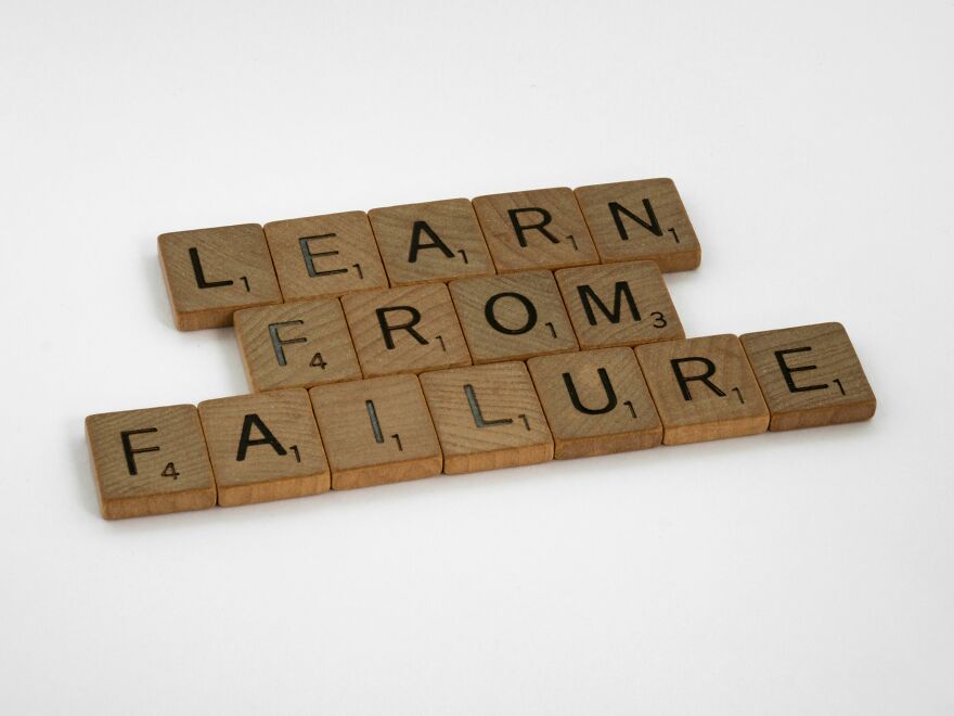 Scrabble tiles arranged to spell learn from failure, symbolizing small behaviors that make people like you more.