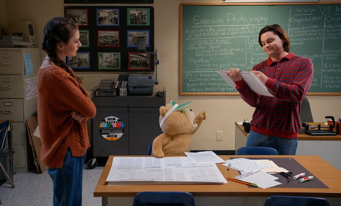 Seth Macfarlane on the set of Ted Season 2, featuring the teddy bear character during a classroom scene.