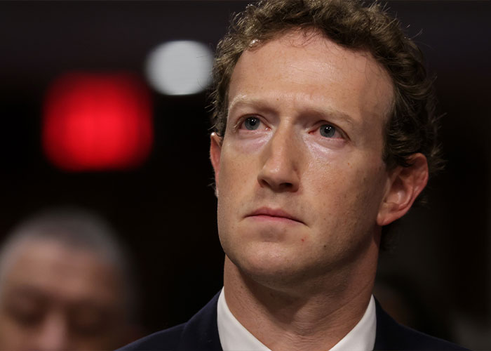 Close-up of a serious man in a suit, highlighting concerns related to Meta workers and smart glasses user content.