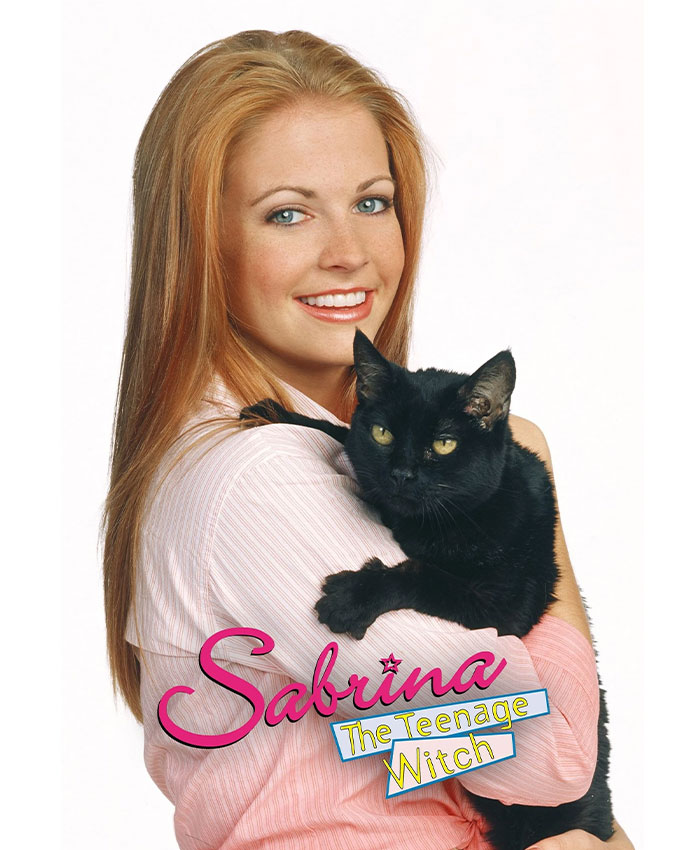 Melissa Joan Hart holding a black cat, smiling, in a tribute to Sabrina The Teenage Witch television show.