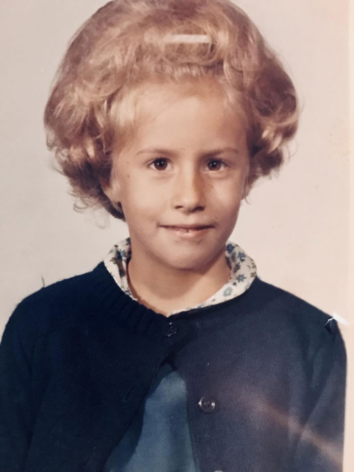 Childhood photo of a girl with a large voluminous hairstyle, showcasing a classic hair disaster from the past.