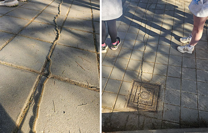 Close-up of a weird and unexplainable twisted crack on pavement near a square metal cover with people standing nearby.