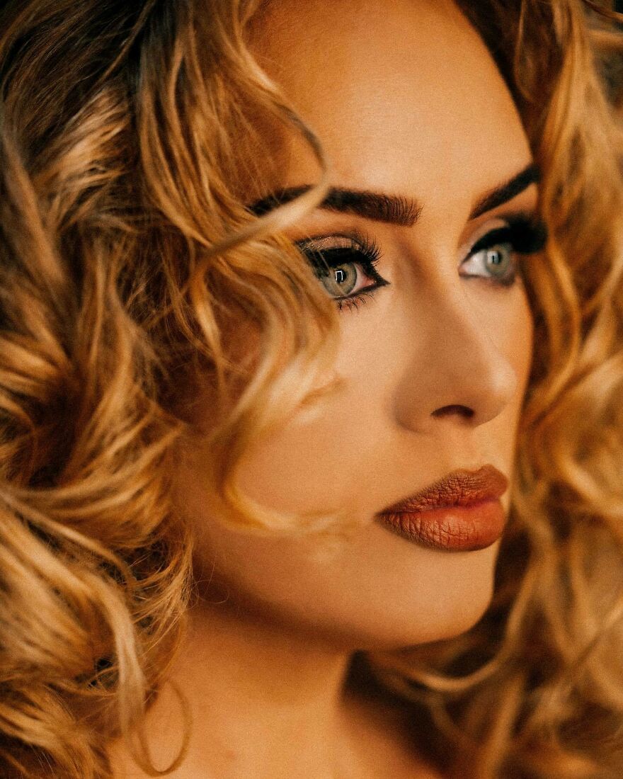 Close-up of a Adele with rare green eyes and curly blonde hair, highlighting eye color genetics and origins. Close-up of a Adele with rare green eyes and curly blonde hair, highlighting eye color genetics and origins.