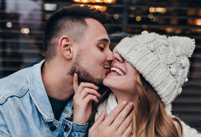 Young couple sharing a tender moment, highlighting the emotional impact of people who lost a friend to a tumour.