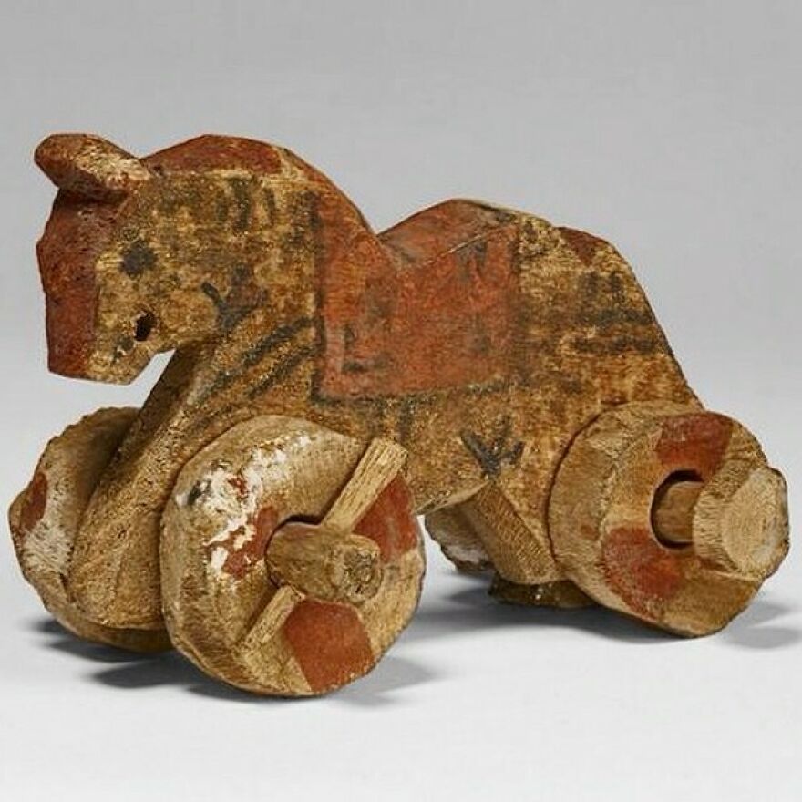 Wooden toy horse with wheels, a curious object showcasing craftsmanship and origins that are even more dazzling and intriguing.