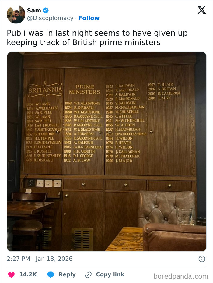 Wooden pub wall listing British prime ministers, showcasing a humorous aspect of living in the UK through social media tweets.