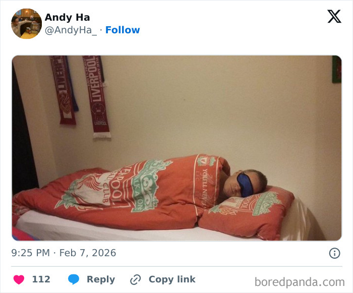Person sleeping in a Liverpool-themed bed with an eye mask, illustrating living in the UK unique experience humor.