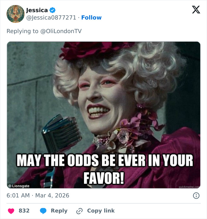 Person dressed in Paris Fashion Week outfits inspired by The Hunger Games, wearing dramatic makeup and a floral headpiece.