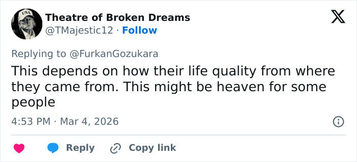 Tweet discussing differing perspectives on life quality related to Dubai labor camps in a social media reply.