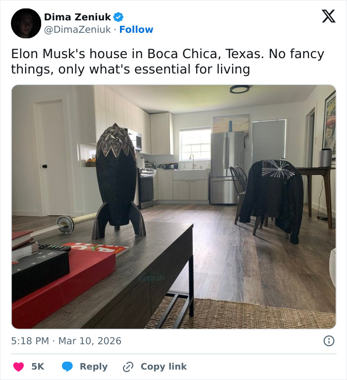 Minimalist interior of Elon Musk's house in Boca Chica with basic kitchen, simple furniture, and an unusual black art piece.