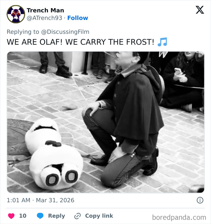 Disney's animatronic Olaf collapsed on the ground while fans reacted and a person kneels beside it during a public event.