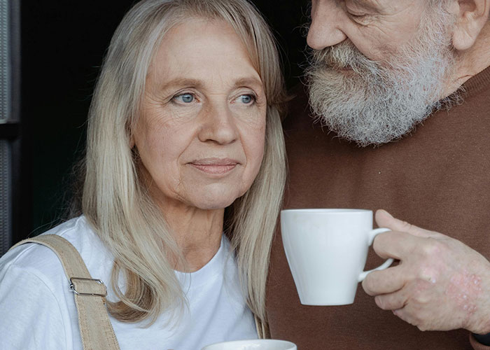 Elderly couple drinking coffee together, capturing a moment that hints at a messy love triangle and chaotic secrets.