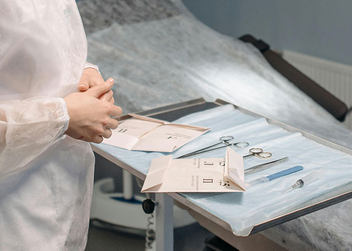Medical secrets revealed with surgical tools and protective gear prepared on a tray in a clinical setting.