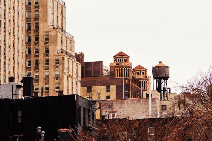 Old buildings and water tower in an urban scene representing haunted places with spine-chilling experiences.