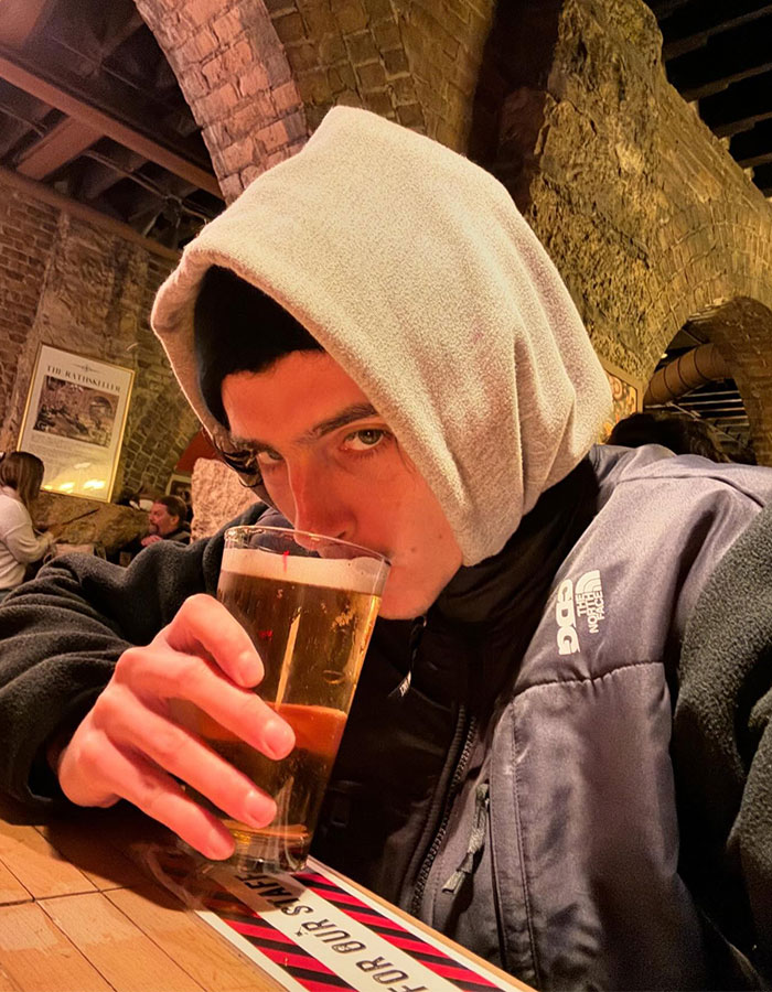 Young man in a hoodie drinking beer indoors, unrelated to Conan O’Brien faces backlash b*m drum joke SEO keywords. Young man in a hoodie drinking beer indoors, unrelated to Conan O’Brien faces backlash b*m drum joke SEO keywords.