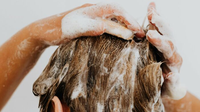 Child washing soapy hair with hands covered in foam, a common nostalgic activity many thought was unique to them.