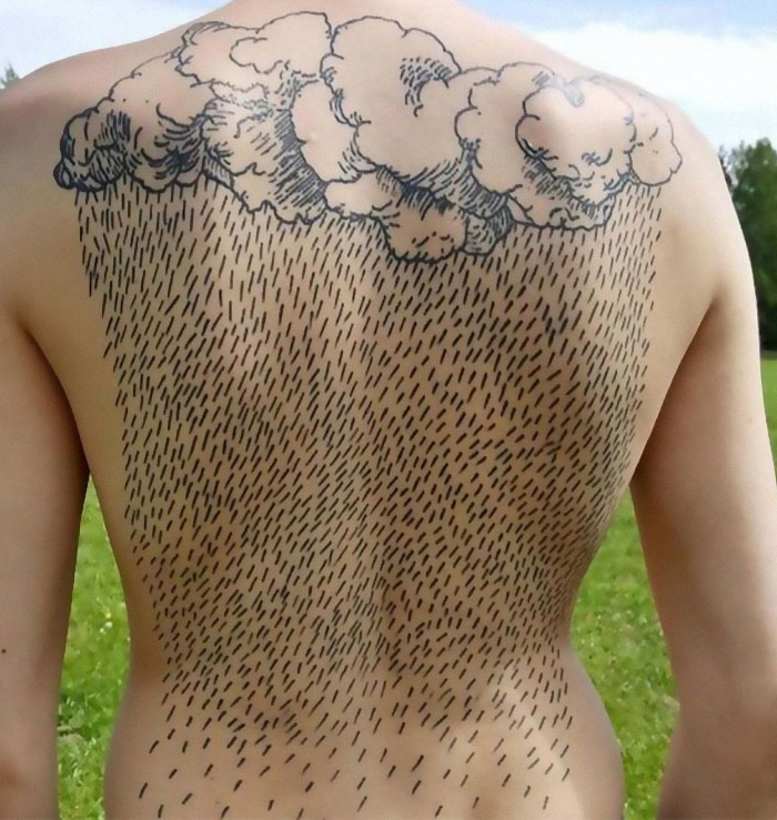 Back tattoo of clouds and rain drawn with ink fail style, showcasing a permanent regret from a bad idea tattoo.