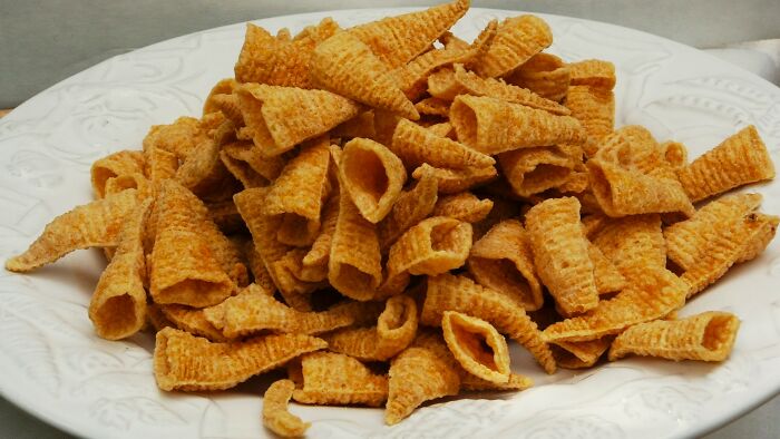 A plate filled with crunchy, golden-brown snack cones, a nostalgic treat many kids enjoyed.