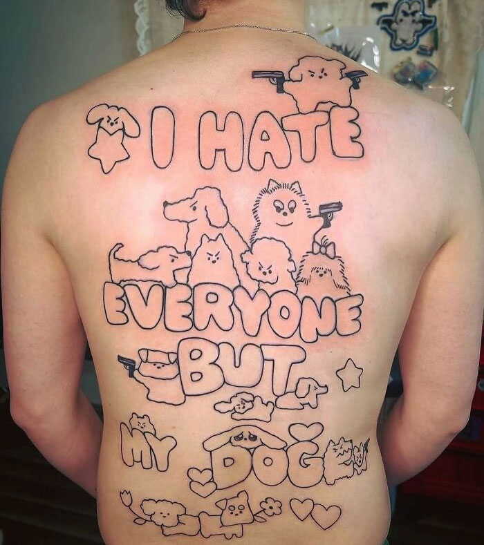 Back tattoo with cartoon-style dogs and text showing a tattoo ink fail mistake with uneven outlines and poor design.