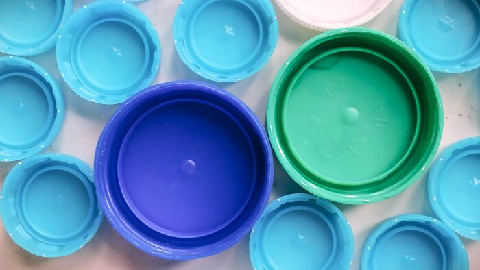 Various colorful plastic bottle caps arranged closely, illustrating nostalgic childhood memories many thought were unique.