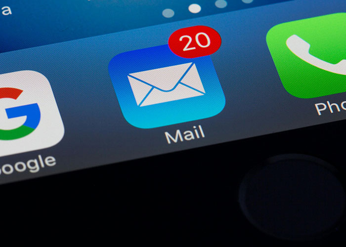 Close-up of a smartphone screen showing a mail app with 20 unread messages related to a messy love triangle.