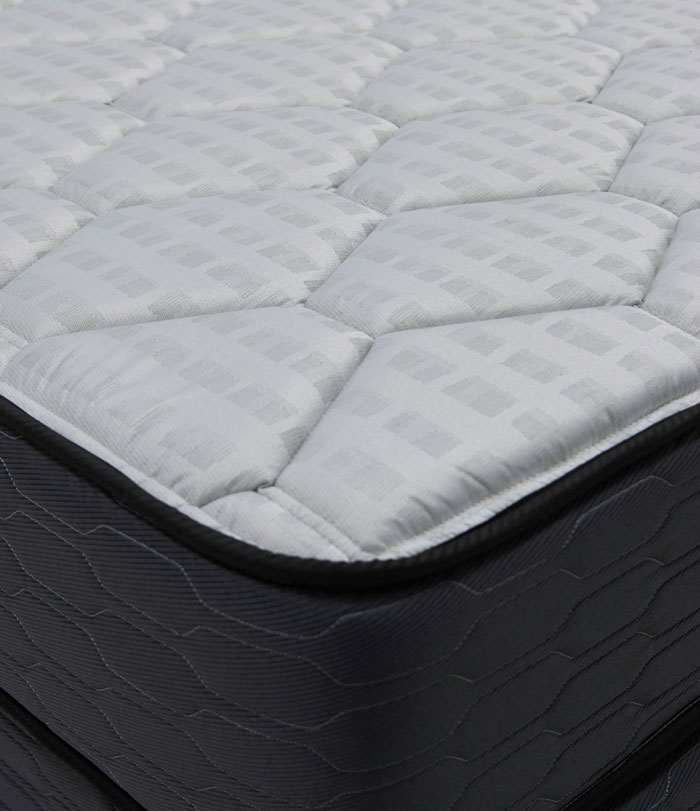 Close-up of mattress surface revealing hidden details tied to shocking corporate secrets customers never knew.